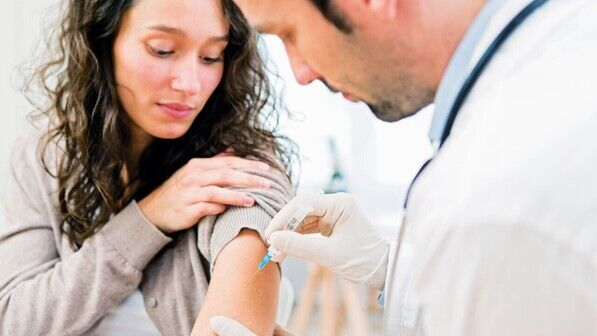 View of a Young attractive woman being vaccinated